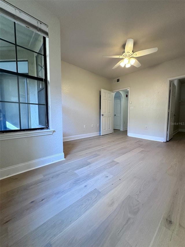 spare room featuring ceiling fan and light hardwood / wood-style flooring