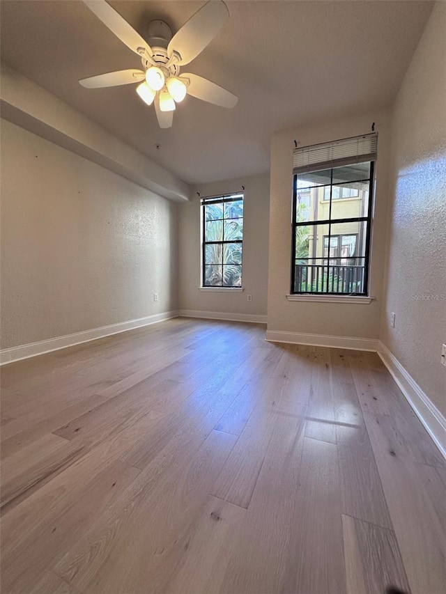 spare room featuring ceiling fan and light wood-type flooring