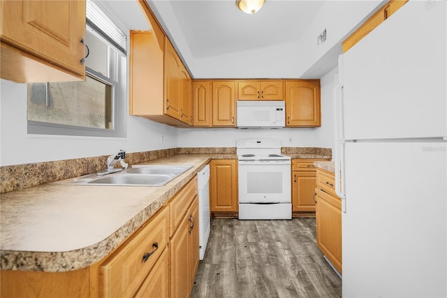 kitchen with lofted ceiling, wood-type flooring, white appliances, and sink