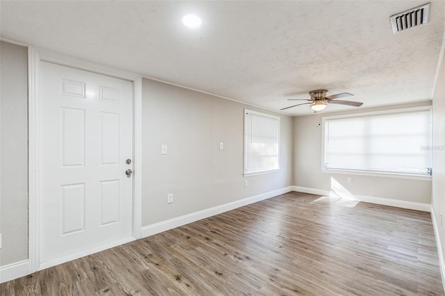 spare room featuring ceiling fan, a textured ceiling, and hardwood / wood-style flooring