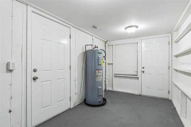 utility room featuring electric water heater