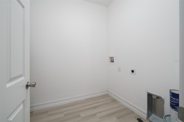 clothes washing area featuring washer hookup, electric dryer hookup, and light hardwood / wood-style floors