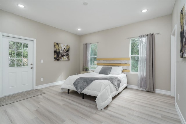 bedroom with light hardwood / wood-style flooring and multiple windows