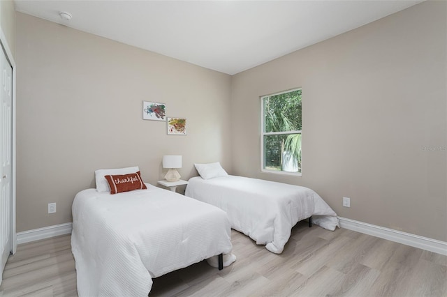 bedroom featuring light wood-type flooring and a closet