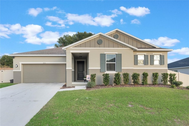 view of front of home with a front yard and a garage