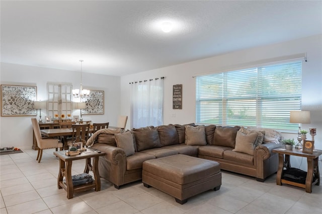 living room with light tile patterned floors and an inviting chandelier