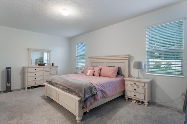 carpeted bedroom featuring a textured ceiling