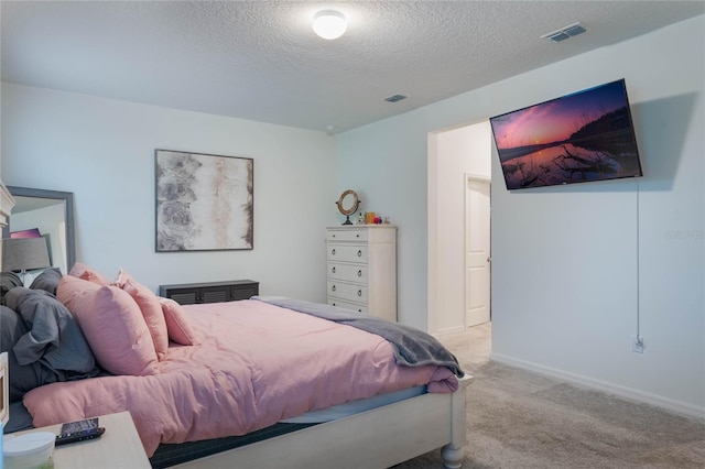 carpeted bedroom with a textured ceiling