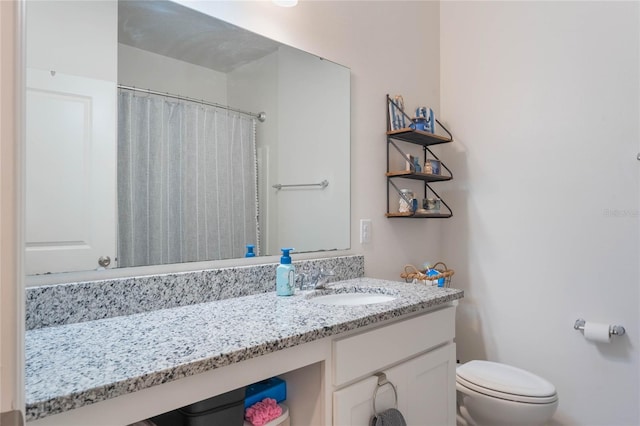 bathroom featuring vanity, toilet, and curtained shower