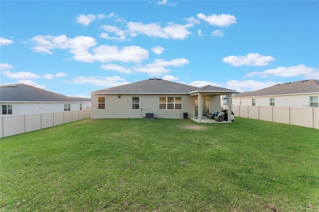 back of house featuring a patio area, a yard, and cooling unit