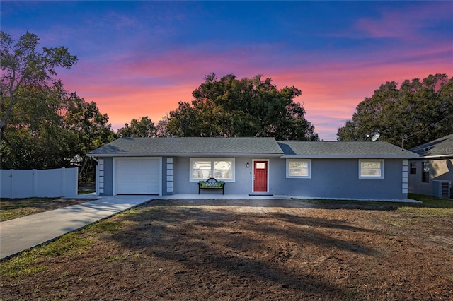 ranch-style house with a yard and a garage