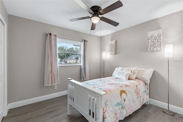 bedroom featuring ceiling fan and dark wood-type flooring