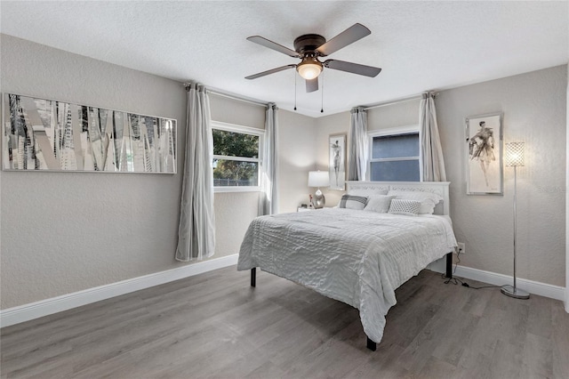 bedroom with ceiling fan and hardwood / wood-style flooring