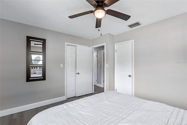 bedroom featuring dark hardwood / wood-style flooring and ceiling fan