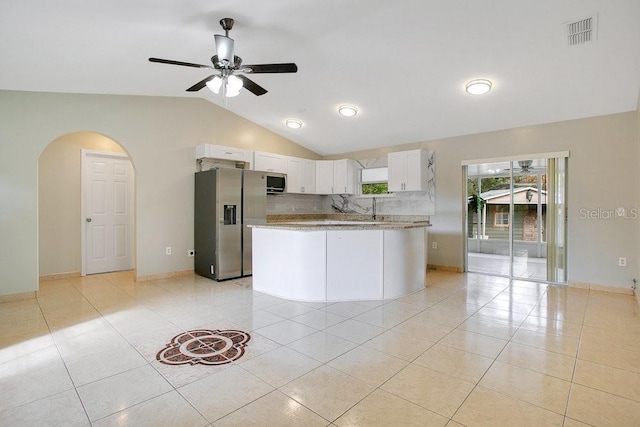 kitchen featuring appliances with stainless steel finishes, backsplash, ceiling fan, light tile patterned floors, and white cabinetry