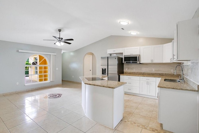 kitchen featuring white cabinets, a kitchen island, sink, and appliances with stainless steel finishes