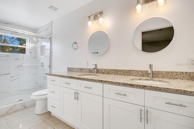 bathroom with vanity, toilet, and a shower with shower door