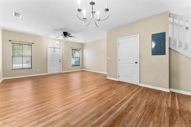 spare room with electric panel, light hardwood / wood-style flooring, and a wealth of natural light