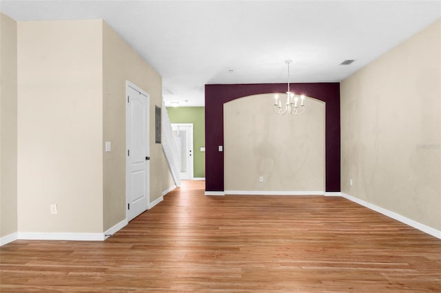 interior space featuring light wood-type flooring and a chandelier