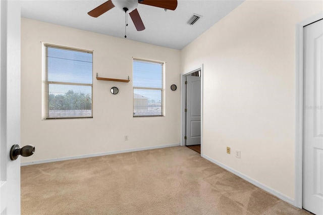 unfurnished room with ceiling fan and light colored carpet