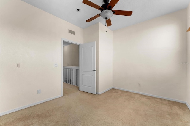 carpeted empty room with ceiling fan