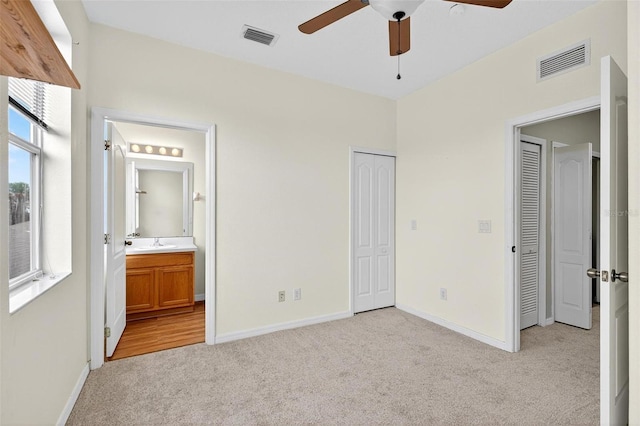 13228 Daniels Landing Cir, Winter Garden, FL 34787 - unfurnished bedroom featuring light carpet, ensuite bath, and ceiling fan
