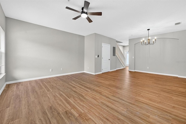 13228 Daniels Landing Cir, Winter Garden, FL 34787 - unfurnished living room featuring a chandelier, light wood finished floors, stairway, and a ceiling fan