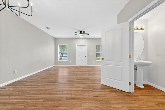 13228 Daniels Landing Cir, Winter Garden, FL 34787 - unfurnished room featuring ceiling fan, light wood-type flooring, and a chandelier