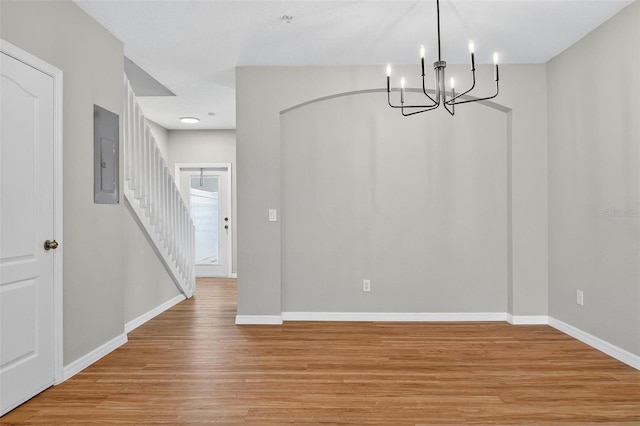 13228 Daniels Landing Cir, Winter Garden, FL 34787 - unfurnished dining area with electric panel, light wood-style floors, a chandelier, and stairway