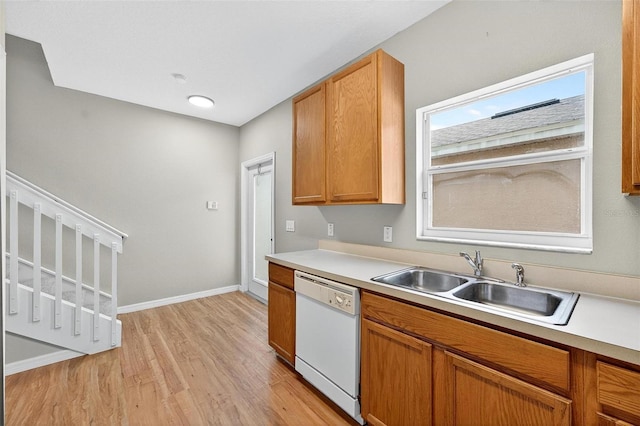 13228 Daniels Landing Cir, Winter Garden, FL 34787 - kitchen with white dishwasher, light wood-style floors, light countertops, and brown cabinetry