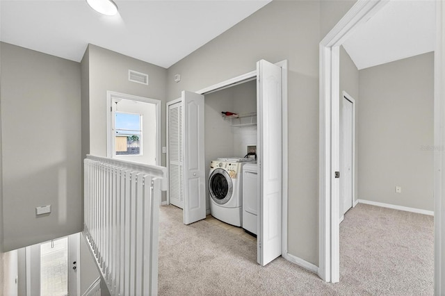 13228 Daniels Landing Cir, Winter Garden, FL 34787 - washroom with washer and clothes dryer, light colored carpet, and radiator heating unit