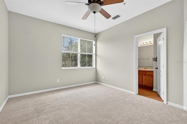 13228 Daniels Landing Cir, Winter Garden, FL 34787 - unfurnished bedroom featuring light colored carpet, ensuite bath, and a ceiling fan