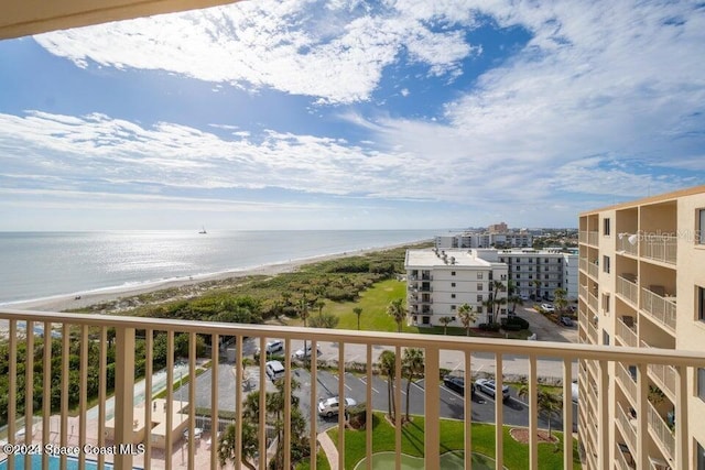 balcony featuring a beach view and a water view