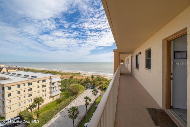 balcony with a water view and a beach view