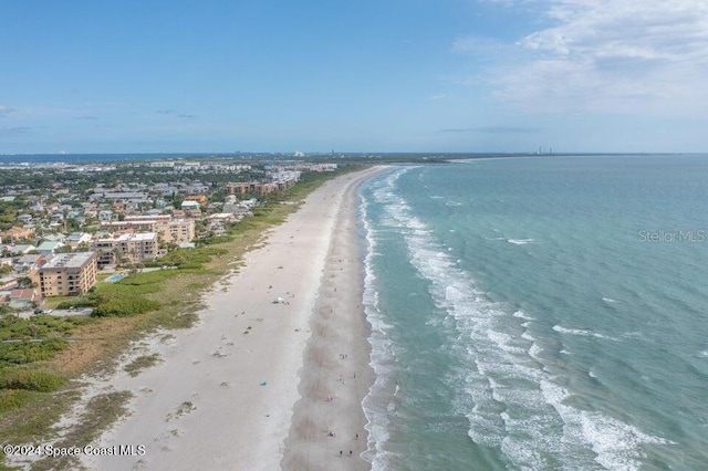 drone / aerial view featuring a water view and a view of the beach