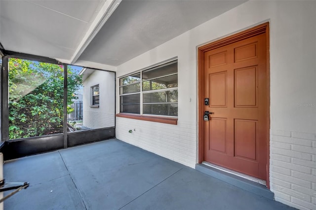 view of exterior entry with a porch