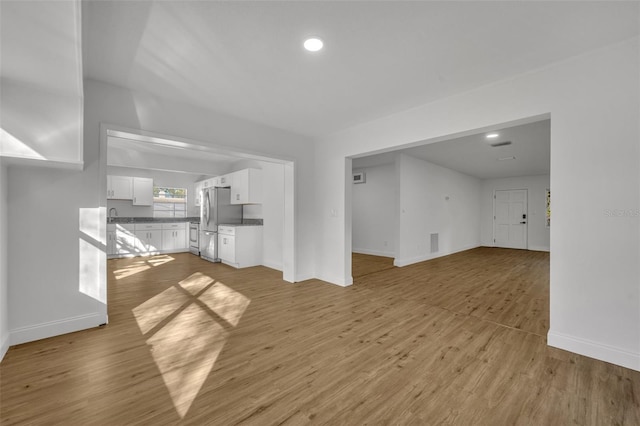 unfurnished living room with light wood-type flooring