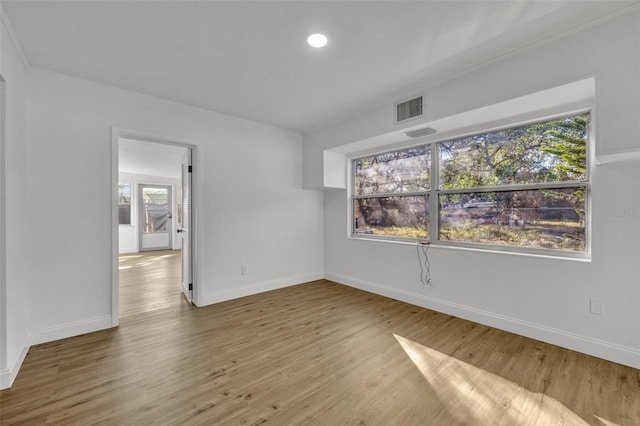 unfurnished room featuring hardwood / wood-style floors and a wealth of natural light