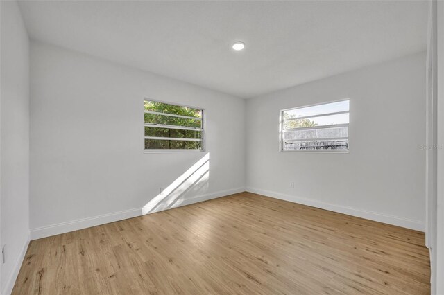 990 Sunrise Dr, Tarpon Springs, FL 34689 - empty room featuring plenty of natural light, baseboards, and wood finished floors