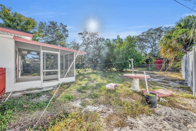 view of yard featuring a sunroom