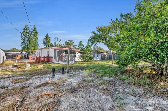 990 Sunrise Dr, Tarpon Springs, FL 34689 - view of yard featuring a sunroom