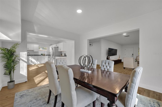 dining area featuring light wood-type flooring