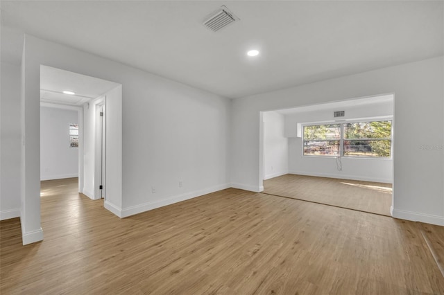 spare room featuring light wood-type flooring