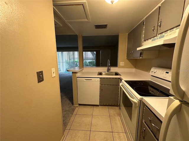 kitchen featuring light carpet, white appliances, and sink