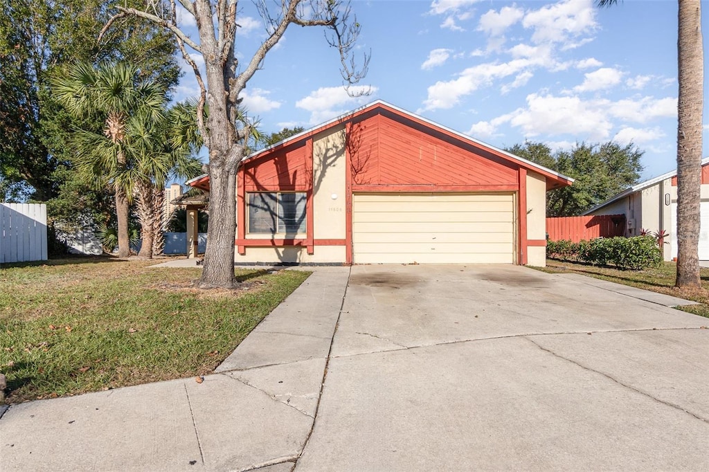 view of front of home with a garage and a front lawn