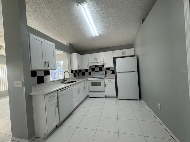 kitchen with a textured ceiling, sink, white cabinets, and white appliances