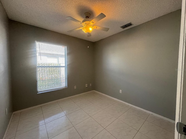 spare room with ceiling fan and a textured ceiling