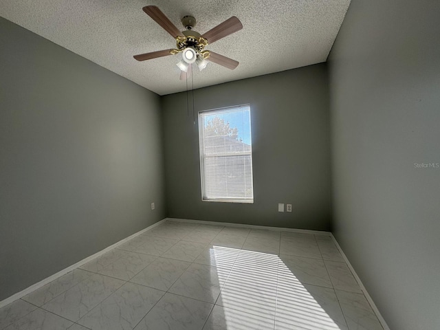 spare room featuring ceiling fan and a textured ceiling