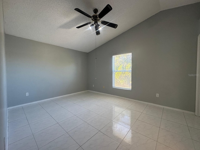 tiled empty room featuring a textured ceiling, vaulted ceiling, and ceiling fan