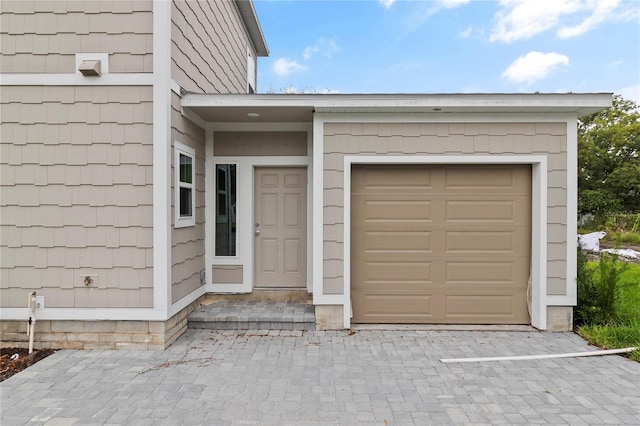 doorway to property with a garage